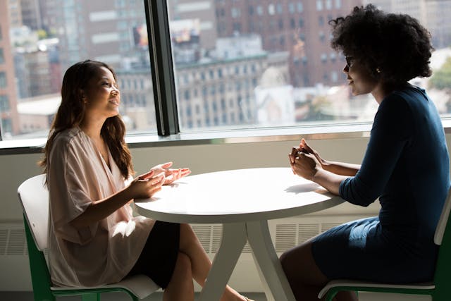 two people talking over around a table